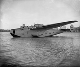 yankee clipper sits in the water while flying an American flag.