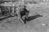 Playing marbles on the first warm day in the spring. In this game the players shoot from hole to hole, the same idea as in golf or miniature golf. Eufaula, Oklahoma.