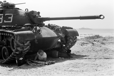 2 soldiers take five in the shade of a tank during the Marine invasion of Lebanon. film negative by Thomas O'Halloran, 1958.