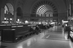 Passengers seated in long benches in the waiting room of Union Station, Washington, D.C.