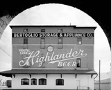 Highlander Beer log prominently featured on the side of a building.