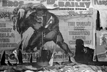 torn circus billboard showing a snarling gorilla holding a man over his head. 