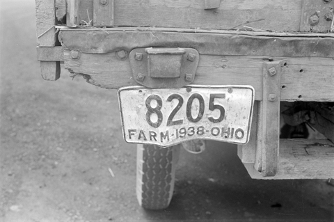 a 1938 ohio license plate hangs froma truck with plate number 8205