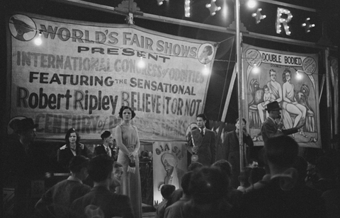 Outdoor carnival, Granville, West Virginia. Banner says Robert Ripley's Believe it or not