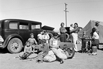 Four families, three of them related with fifteen children, from the Dust Bowl in Texas stay in an overnight roadside camp near Calipatria, California