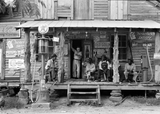 Sunday Afternoon, July 1939 - Gordonton, North Carolina showing a country store on dirt road. Check out kerosene pump on the right and the gasoline pump on the left. The brother of the store owner stands in doorway.