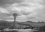 Sheep ranch of Charles McKenzie in Garfield County Montana. windmill showing with badlands in the background.